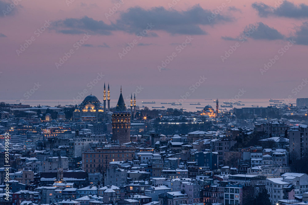 Galata tower in Istanbul, Turkey. Aerial view of landmark at golden hour with beautiful sunlight. Snow and winter season view in Istanbul.