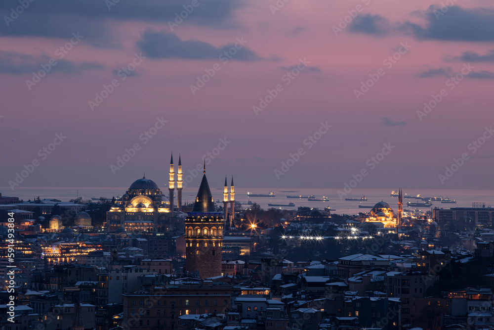 Galata tower in Istanbul, Turkey. Aerial view of landmark at golden hour with beautiful sunlight. Snow and winter season view in Istanbul.