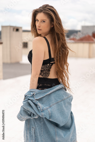 female model posing outdoors, young latin woman with long hair and natural beauty, wears jean jacket, bralette and shorts, lifestyle