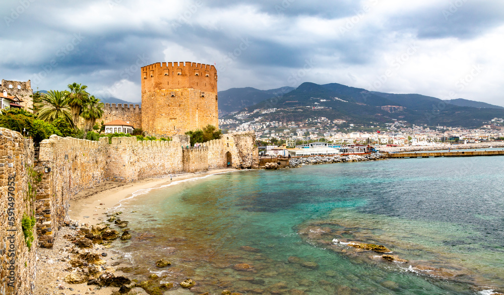 Alanya Harbour and The Red Tower, Alanya, Antalya Province, Turkey. Popular tourist Turkish city located on the Mediterranean Sea. Kizil kule tower.