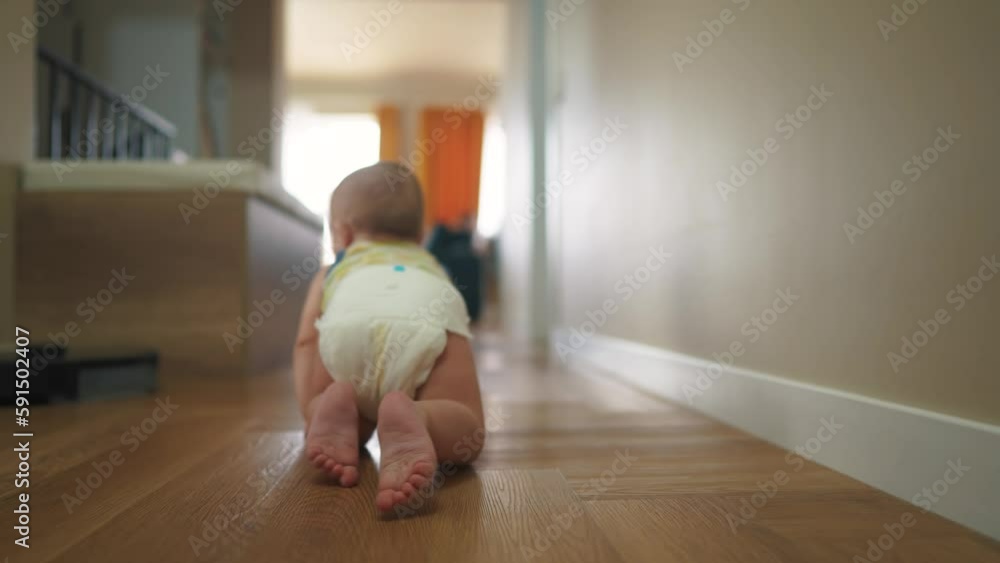 baby newborn crawling on the floor. happy family kindergarten kid concept. First steps, baby crawling view from the back. baby learns to crawl to explore the world dream lifestyle. first steps creeps baby newborn crawling on the floor. happy family kindergarten kid concept. First steps, baby crawling view from the back. baby learns to crawl to explore the world dream lifestyle. first steps creeps