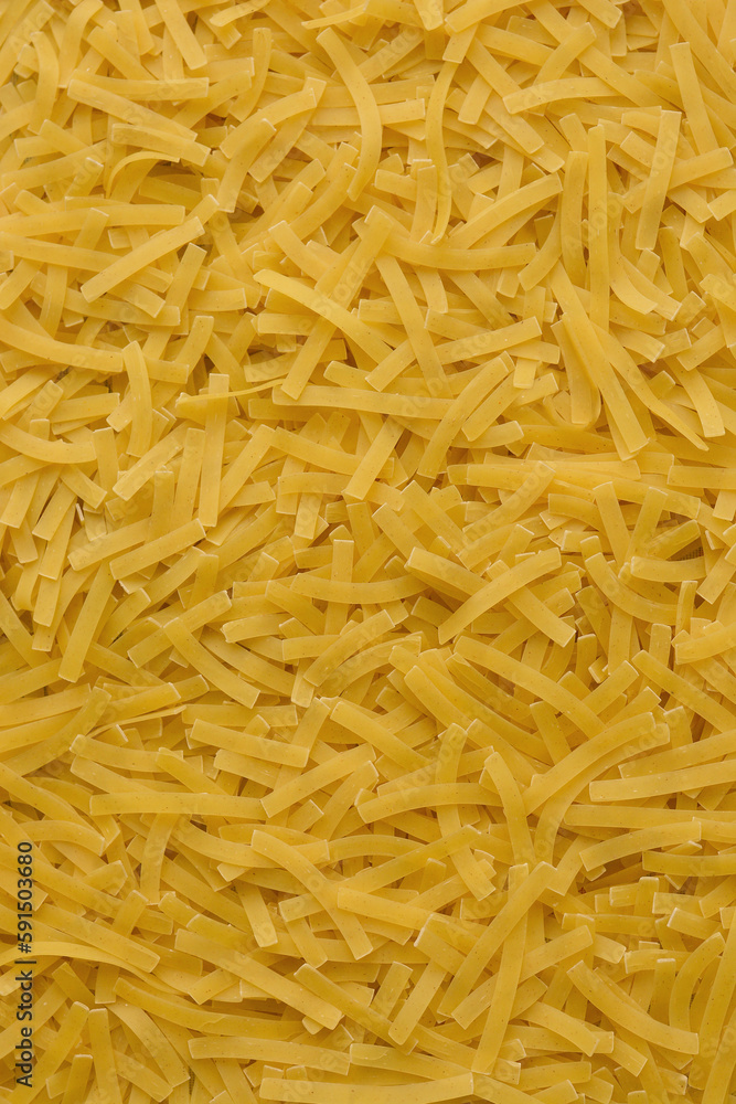 Yellow background with raw vermicelli noodles. Concept - pasta as background. Yellow background with raw vermicelli noodles. Concept - pasta as background.