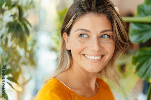 Thoughtful happy woman with blond hair in cafe photo