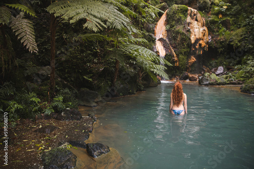 Woman standing in natural thermal water