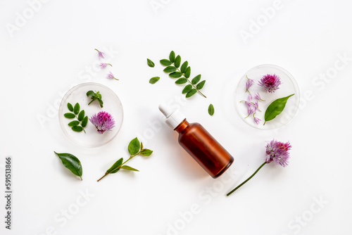 Medical herbs oil on dropper bottle. Herbal serum or essential oil