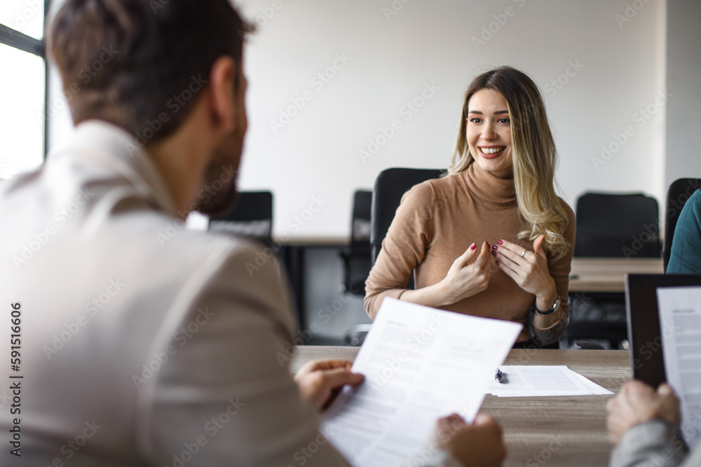 Happy female candidate on a job interview in the office. - obrazy, fototapety, plakaty 