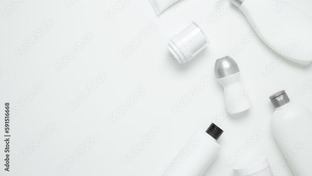 Cosmetic beauty products on white background. Bottles and tubes with branding mock up. Skin care and beauty concept. Top view, flat lay, copy space, banner Cosmetic beauty products on white background. Bottles and tubes with branding mock up. Skin care and beauty concept. Top view, flat lay, copy space, banner
