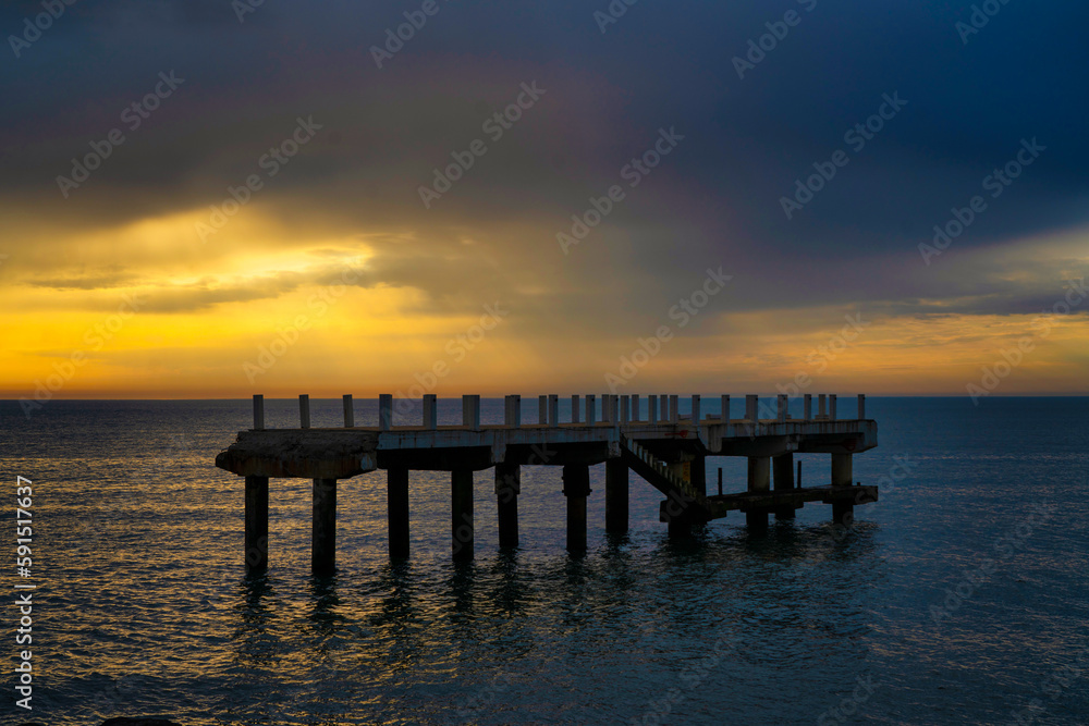 Pier on the sea at sunset