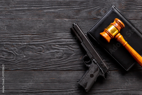 Hand gun weapon and judges gavel. Ban on carrying weapons gun law concept