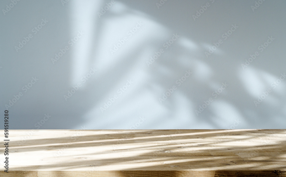 Table shadow background. Wooden table and white empty wall with plant shadows. - obrazy, fototapety, plakaty 