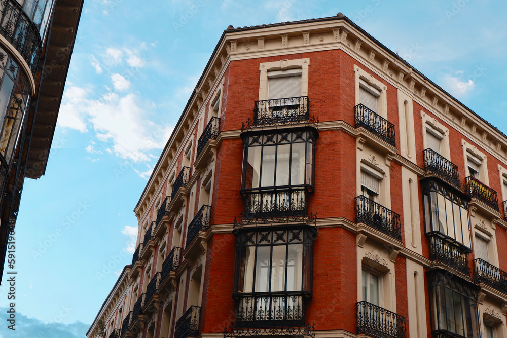 Fototapeta premium Classy vintage buildings with elegant black metallic balconies in the center of Madrid, Chueca district, Spain