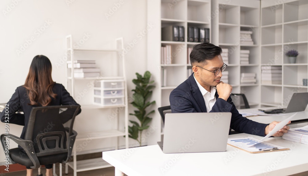 Business man working at the office and smiling . Business man working at the office and smiling .