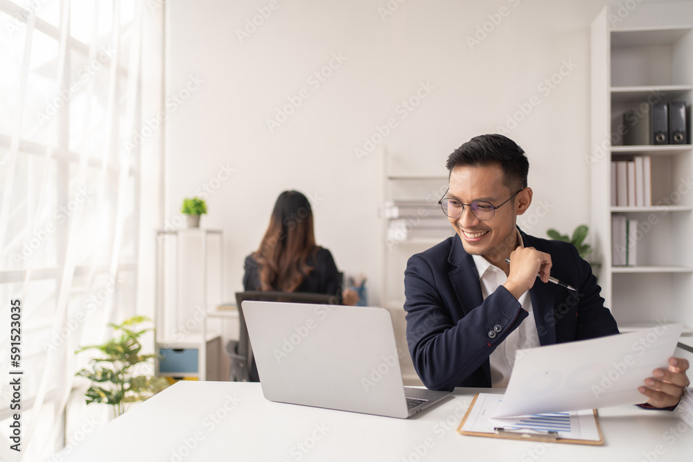 Business man working at the office and smiling . Business man working at the office and smiling .