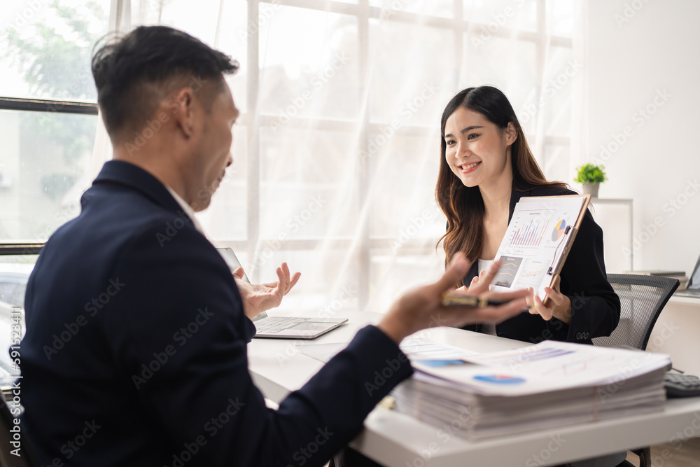 The couple of business talking about the project and make deal in the office. The couple of business talking about the project and make deal in the office.