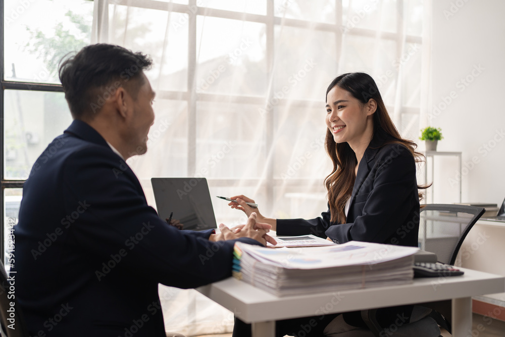 The couple of business talking about the project and make deal in the office. The couple of business talking about the project and make deal in the office.