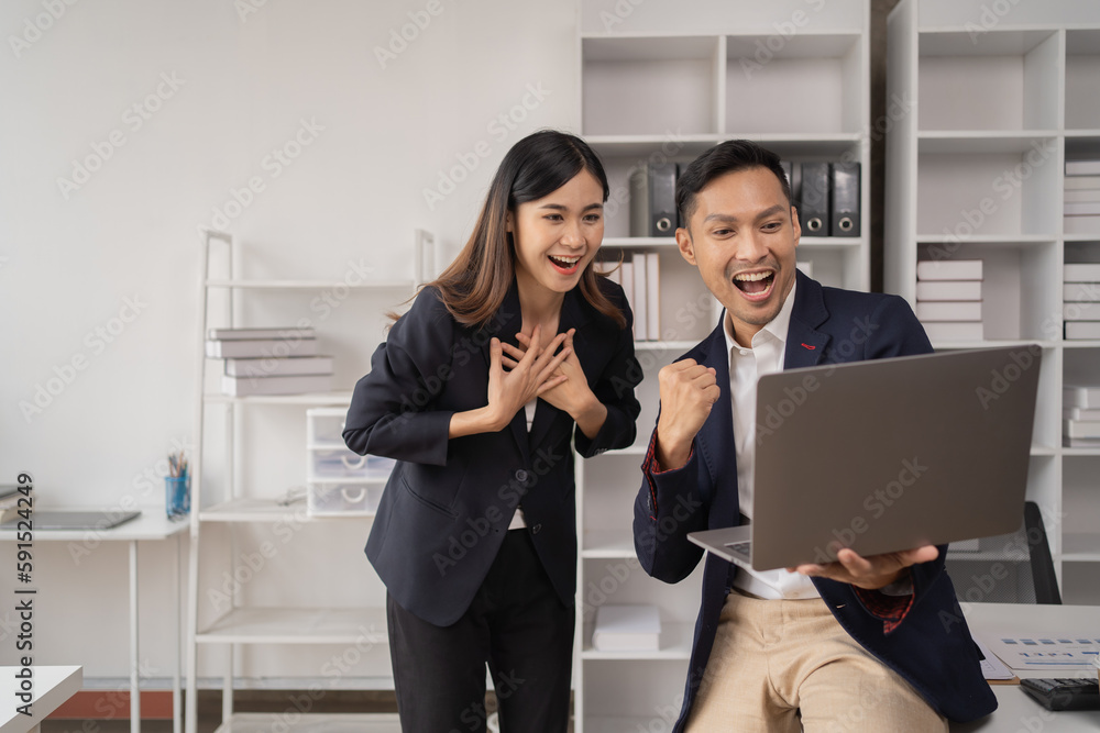 The couple of business employee working in the office with laptop and holding the coffee cup, happy, The couple of business employee working in the office with laptop and holding the coffee cup, happy,