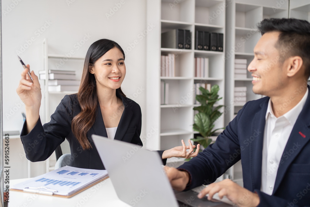 Close-up of a businessman shaking hands with a young Asian female, Work with document in the office. Close-up of a businessman shaking hands with a young Asian female, Work with document in the office.