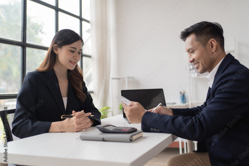 Young happy woman applying for job and giving she's CV to a manager during the interview and shakehand in the office. Young happy woman applying for job and giving she's CV to a manager during the interview and shakehand in the office.