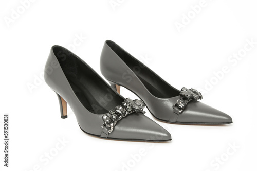 Grey leather pumps with rhinestones isolated on white. Classic middle heels with sharply pointed toes.
