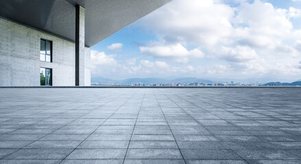 Empty square floor and city skyline with building background