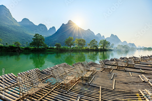 Landscape of Guilin, Li River and Karst mountains. Located near Yangshuo, Guilin, Guangxi, China. Bamboo raft moor on the river.