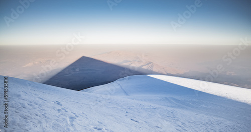 View from the top of Mount Ararat with snow and glacier in the morning, and a conical shadow from Mount Ararat