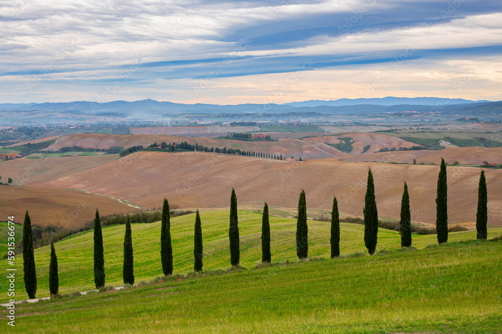 Beautiful Italian Landscape in Tuscany with famous cypress trees and interesting sky. Tuscany in autumn.