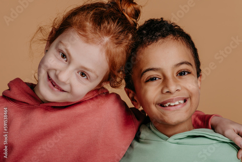Boy with his friend posing during studio shoot.