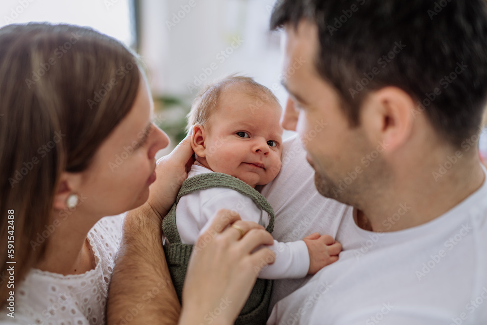 Happy parents cuddling with their newborn baby. Happy parents cuddling with their newborn baby.