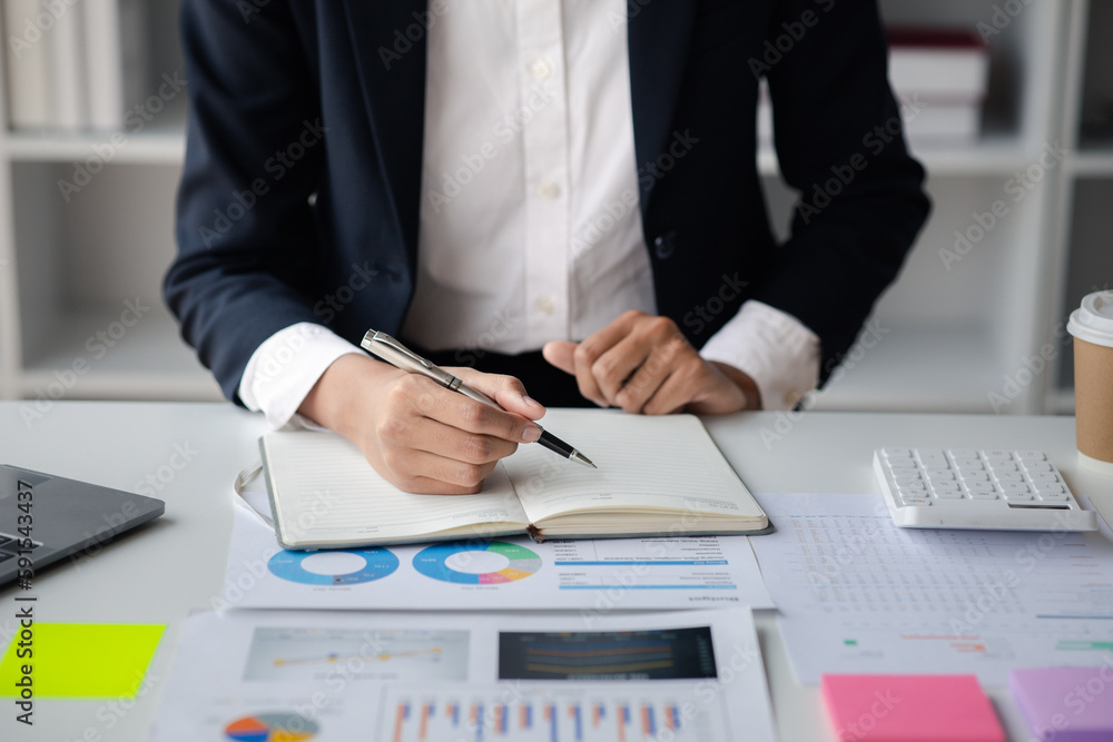 Naklejka premium Businessman working in a private office, she is reviewing the company's financial documents sent from the finance department before he takes it to a meeting with a business partner. Financial concept.