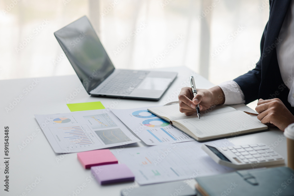Businessman working in a private office, she is reviewing the company's financial documents sent from the finance department before he takes it to a meeting with a business partner. Financial concept. Businessman working in a private office, she is reviewing the company's financial documents sent from the finance department before he takes it to a meeting with a business partner. Financial concept.