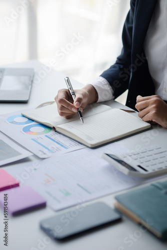Fototapeta Naklejka Na Ścianę i Meble -  Businessman working in a private office, she is reviewing the company's financial documents sent from the finance department before he takes it to a meeting with a business partner. Financial concept.