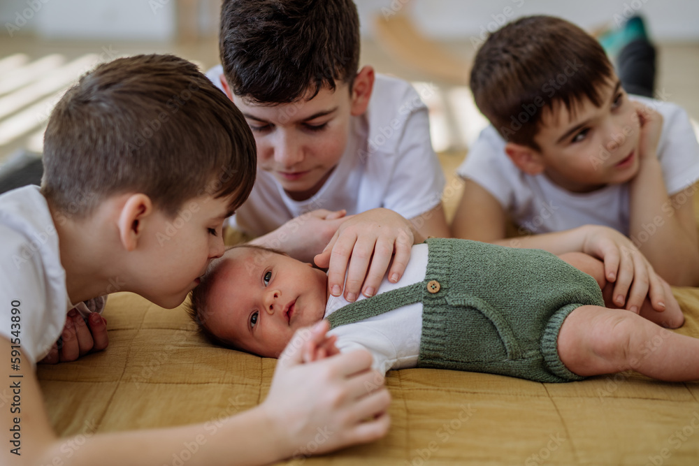 Three big brothers with their little newborn brother. Three big brothers with their little newborn brother.