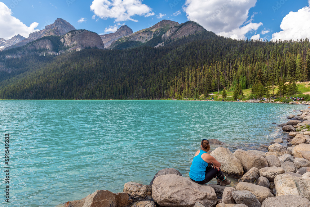 Young woman in sportswear enjoying the view of Lake Louise with copy space, Banff national park, Alberta, Canada. Young woman in sportswear enjoying the view of Lake Louise with copy space, Banff national park, Alberta, Canada.