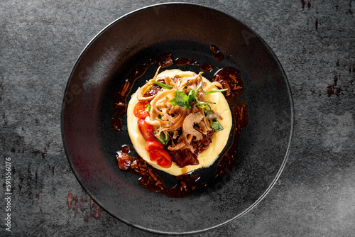 Stewed veal cheeks with mashed potatoes on plate photo