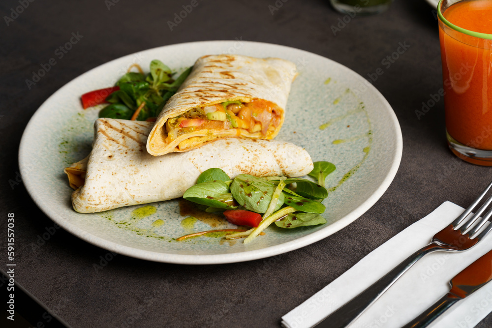 Wrapped Burrito with Beans and Vegetables on a Plate Wrapped Burrito with Beans and Vegetables on a Plate