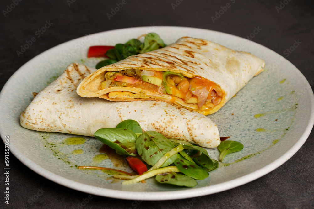 Wrapped Burrito with Beans and Vegetables on a Plate Wrapped Burrito with Beans and Vegetables on a Plate