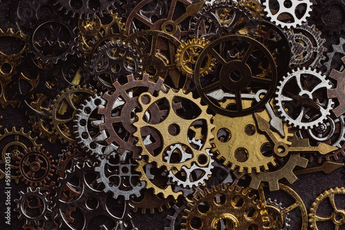 Shiny gears of cold steel colors on dark background