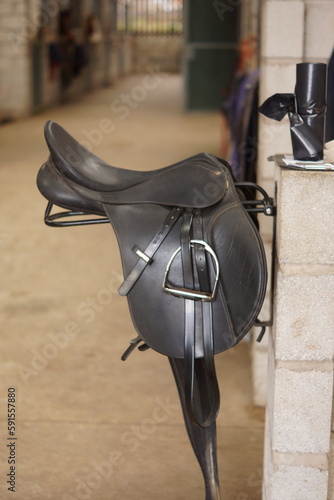 English synthetic Saddle on rack in stable yard