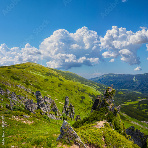 Fototapeta Naklejka Na Ścianę i Meble -  green mountain chain under blue cloudy sky