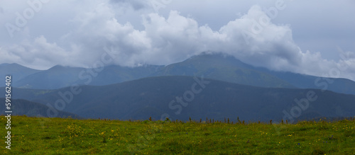 wet mountain valley at foggy cloudy day photo