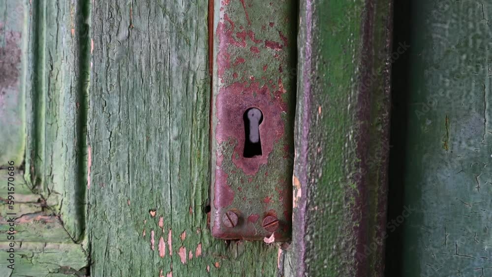 Keyhole on the old door lock. Old wooden door from the house.