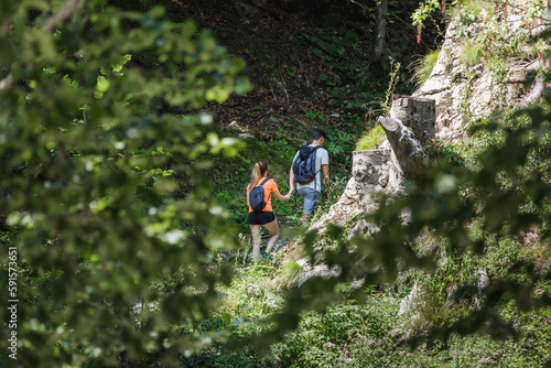 Wallpaper Mural Two young hikers with backpacks, a couple in love exploring nature Torontodigital.ca