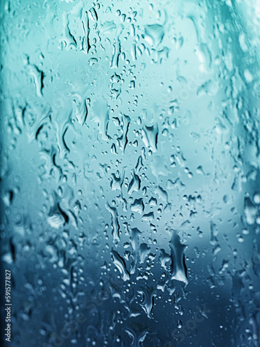 Raindrops on glass. Flowing drops of water. Selective focus.