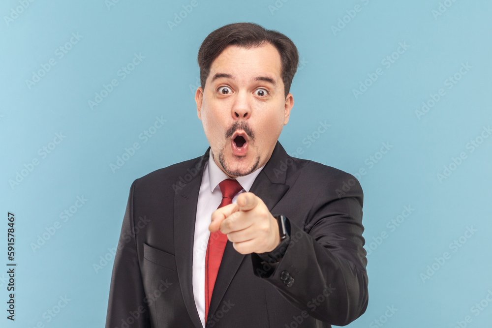 Shocked surprised astonished man standing and pointing at you, looking