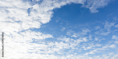 Fotografie Blue sky texture with white altocumulus clouds on a sunny day