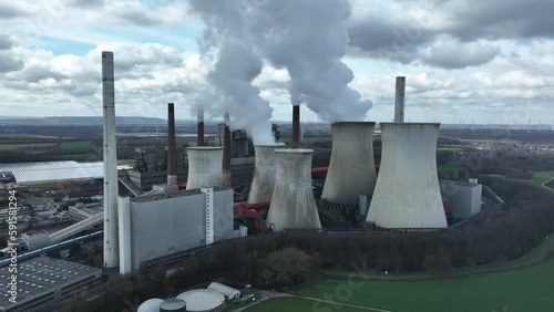 An impressive aerial drone view of the massive Neurath power station, with towering cooling towers, smokestacks, and other industrial structures. photo