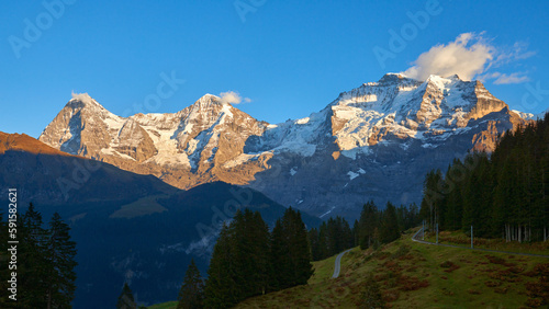 Mountain view of Jungfrau, Monch, Eiger peaks at sunset in Switzerland Bernese region.