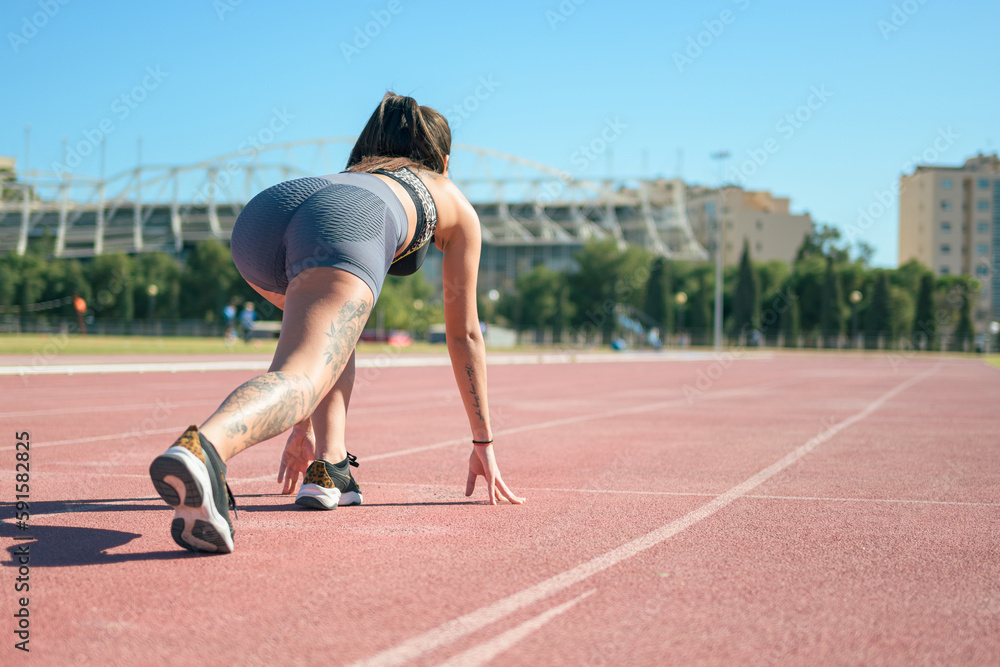 Fototapeta premium Fitness runner woman on running track working out