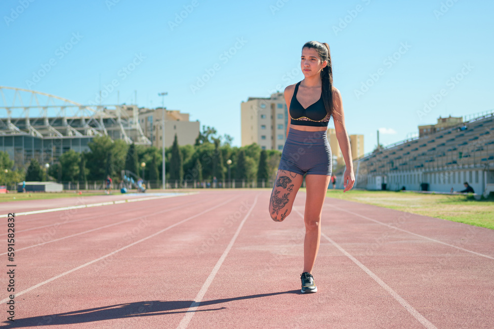 Runner woman warming up on track in the morning light